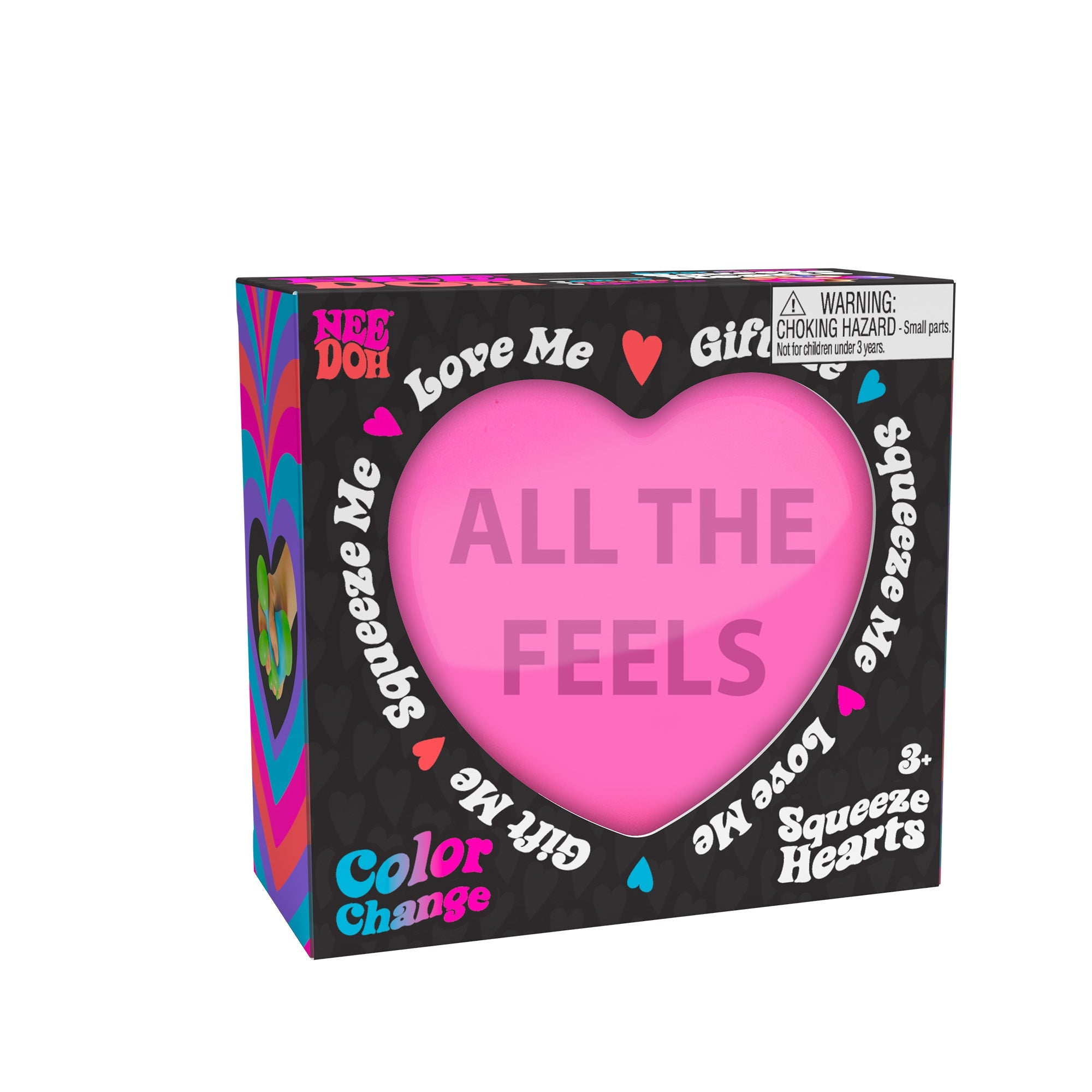 A boxed Color Change Squeeze Heart S3 toy. The packaging is predominantly black with colorful accents, featuring phrases like "ALL THE FEELS," "Squeeze Me," "Love Me," and "Gift Me." The box also includes a choking hazard warning for small parts.